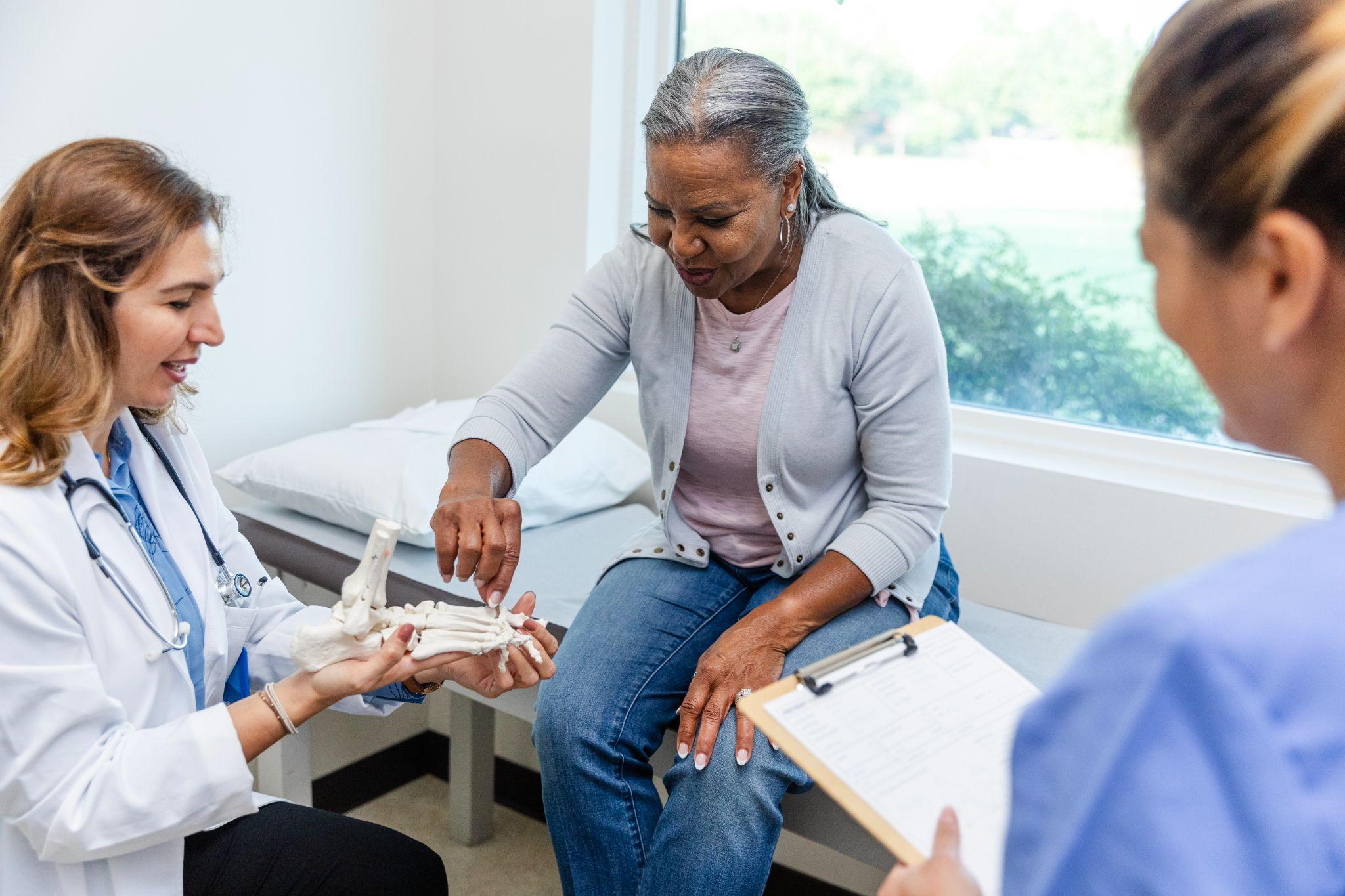 An older adults visits the doctor in regards of their bone health.